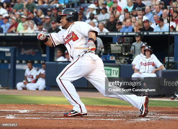 Melky Cabrera of the Atlanta Braves breaks his bat while hitting against the New York Mets at Turner Field on May 18, 2010 in Atlanta, Georgia. The...