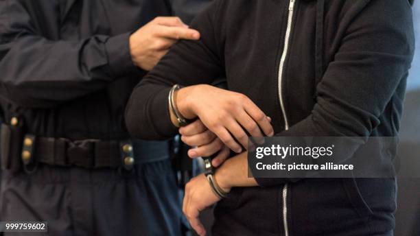 The defendant Nasser A. Is brought into the court room at the district court in Dresden, Germany, 8 September 2017. The 25 year old Syrian man is...
