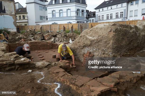 Researchers dig up a Roman floor heating system at an excavation site in Remagen, Germany, 7 September 2017. During the excavations, human bones were...