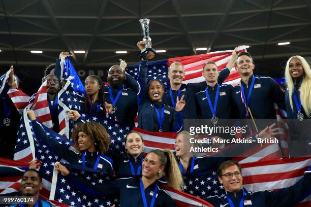 Captain Queen Harrison poses with the trophy among team mates as Team USA celebrate victory during Day Two of the Athletics World Cup 2018 at London...