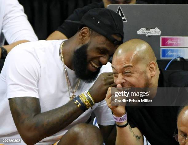 LeBron James of the Los Angeles Lakers and his friend Paul Rivera share a laugh as they attend a quarterfinal game of the 2018 NBA Summer League...