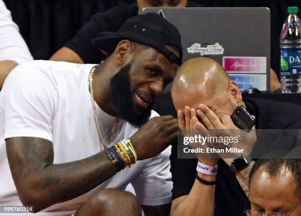 LeBron James of the Los Angeles Lakers and his friend Paul Rivera share a laugh as they attend a quarterfinal game of the 2018 NBA Summer League...