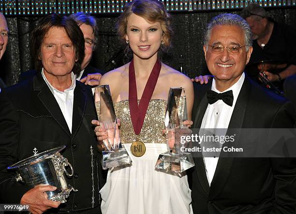 Musician John Fogerty, musician Taylor Swift and BMI President and CEO Del Bryant pose during the 58th Annual BMI Pop Awards held at the Beverly...