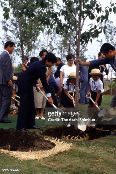 Prince Naruhito plants a tree during the Urban Greenery Festival at Yurigahara Park on August 19, 1986 in Sapporo, Hokkaido, Japan.