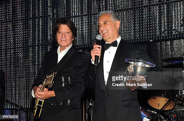 Musician John Fogerty and BMI President and CEO Del Bryant speak onstage during the 58th Annual BMI Pop Awards held at the Beverly Wilshire Hotel on...