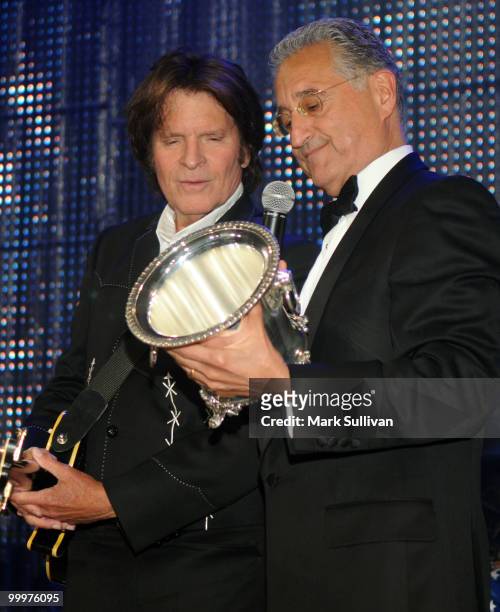 Musician John Fogerty and BMI President and CEO Del Bryant speak onstage during the 58th Annual BMI Pop Awards held at the Beverly Wilshire Hotel on...