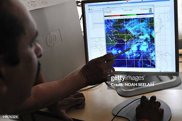 Meteorologists keep tabs on Cyclone Laila on a computer screen at the Indian Meteorological Department in Hyderabad on May 19, 2010. Heavy rains and...