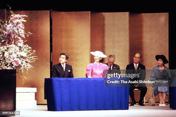 Crown Prince Akihito addresses while Crown Princess Michiko listens during the 52nd International Federation of Library Associations and Institutions...