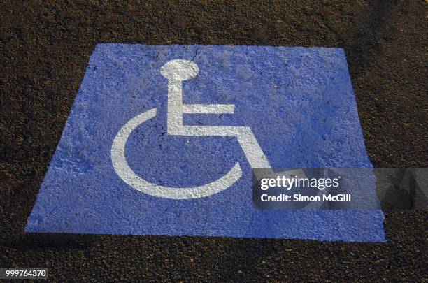 international symbol of access (isa), also known as the wheelchair symbol, on a parking space - australian capital territory stock pictures, royalty-free photos & images