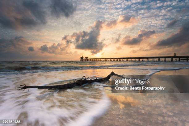 beautiful sunrise on the beach with the port - songkhla province stock pictures, royalty-free photos & images
