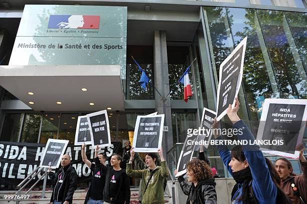Activists of French branch of Act Up demonstrate in front of the Health ministry on May 19, 2010 in Paris, after they covered the steps of the Health...
