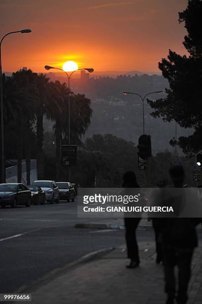 Residents of Johannesburg make their way home after work as the sun sets on May 18, 2010 in Johannesburg, South Africa. South Africa will host the...