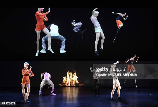 Dancers perform in front of a giant screen featuring themselves during their first performance before an audience of the Orphee opera, choregraphed...