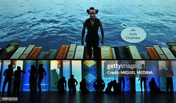 Dancers perform in front of a giant screen during their first performance before an audience of the Orphee opera, choregraphed by French Jose...