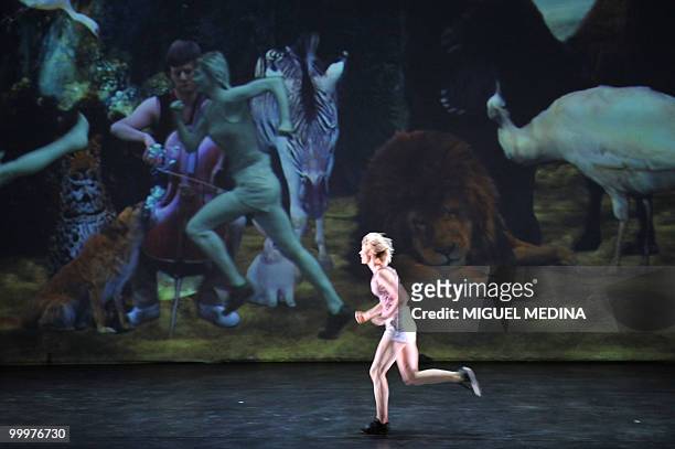Dancer performs in front of a giant screen during the first performance before an audience of the Orphee opera, choregraphed by French Jose Montalvo...