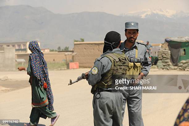 Afghan policemen stand guard on a road leading to the US air base in Bagram, 50 kms north of Kabul, on May 19, 2010. Taliban militants armed with...