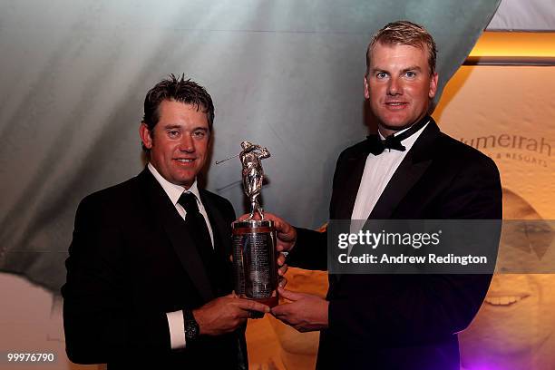 Lee Westwood of England is presented with The Harry Vardon Trophy by Robert Karlsson of Sweden during the 2010 Tour Dinner prior to the BMW PGA...