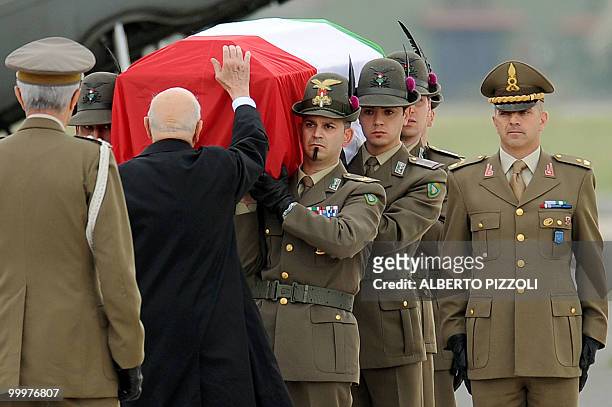Italian President Giorgio Napolitano pays his respects at a coffin of one of the two Italian Alpine troops of the NATO-led International Security...