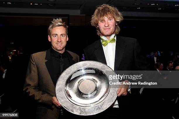 Ian Poulter of England presents the Rookie of the Year award to Chris Wood of England the 2010 Tour Dinner prior to the BMW PGA Championship on the...