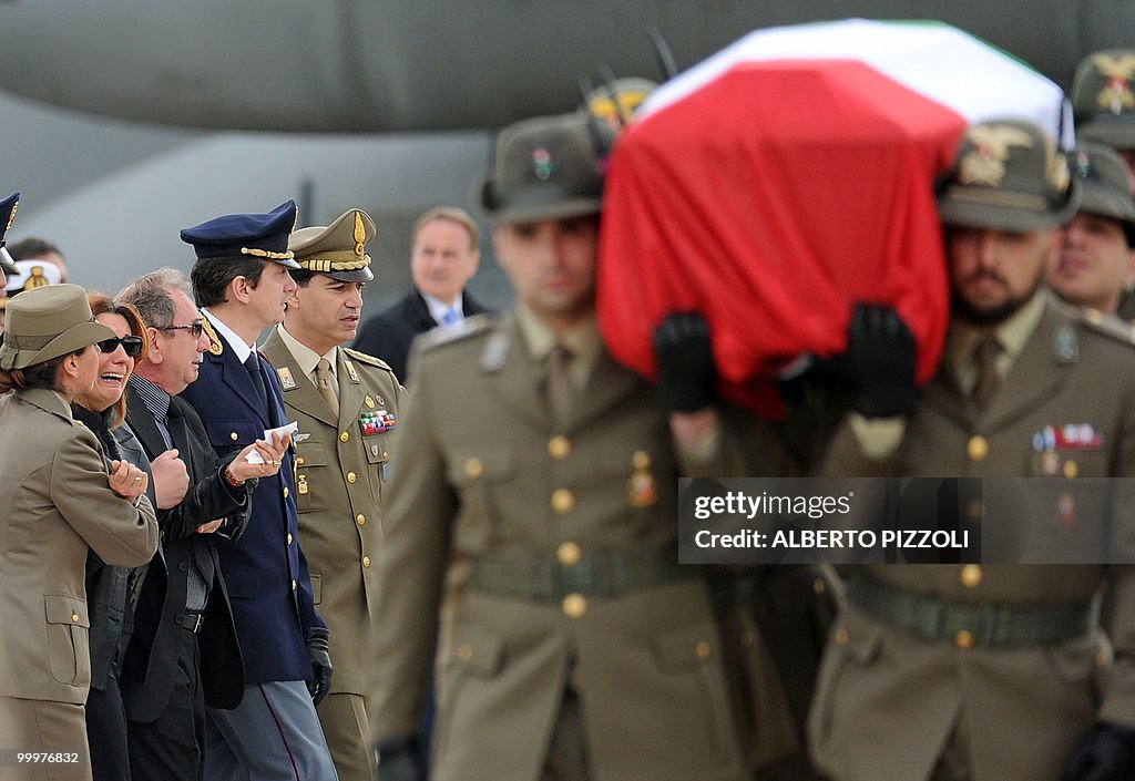 Relatives express their grief beside a c