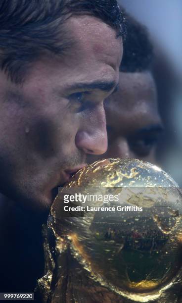 Antoine Griezmann of France kisses the World Cup trophy during the victory celebrations after the 2018 FIFA World Cup Russia Final between France and...