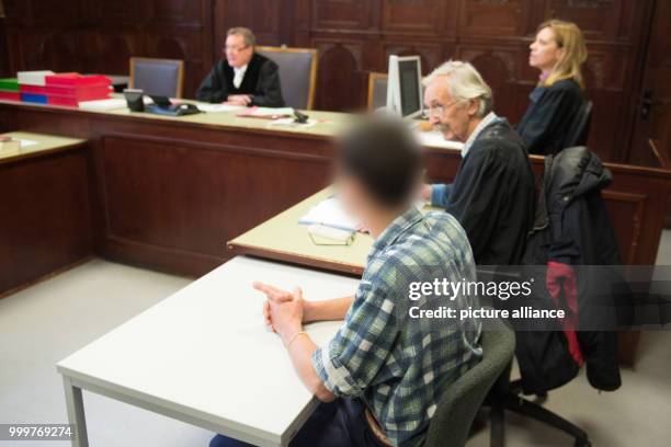 The defendant sits next to his lawyer Thomas Herzog in a court room of the district court Altona in Hamburg, Germany, 8 September 2017. The young man...