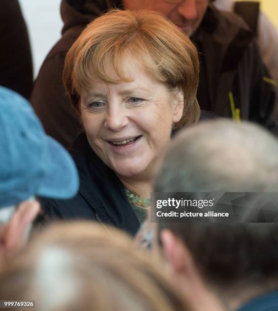 German chancellor Angela Merkel speaks to people and poses for photographs at the market place in Barth, Germany, 8 September 2017. Photo: Stefan...