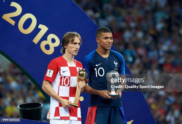 Luka Modric of Croatia and Kylian Mbappe of France pose respectively with their the adidas Golden Ball and with the FIFA Young Player award following...