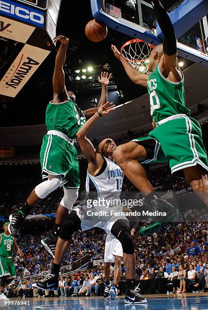 Kendrick Perkins and Ray Allen of the Boston Celtics swarm over Vince Carter of the Orlando Magic going for a loose ball in Game Two of the Eastern...