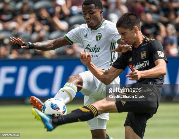 Alvas Powell of Portland Timbers battles Joao Moutinho of Los Angeles FC at the Banc of California Stadium on July 15, 2018 in Los Angeles,...