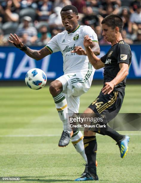 Alvas Powell of Portland Timbers battles Joao Moutinho of Los Angeles FC at the Banc of California Stadium on July 15, 2018 in Los Angeles,...