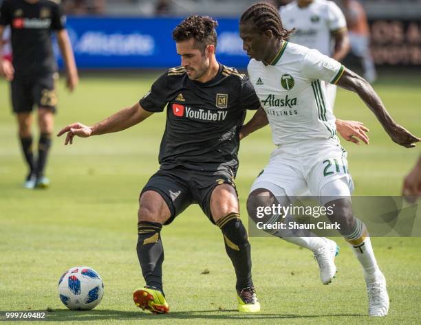 Benny Feilhaber of Los Angeles FC battles Diego Chara of Portland Timbers at the Banc of California Stadium on July 15, 2018 in Los Angeles,...