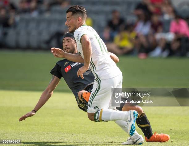 Lee Nguyen of Los Angeles FC fouls Andy Polo of Portland Timbers and was given a red card at the Banc of California Stadium on July 15, 2018 in Los...