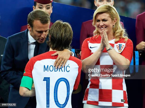 French President Emmanuel Macron embraces Luka Modric of Croatia as President of Croatia, Kolinda Grabar Kitarovic looks on after the 2018 FIFA World...