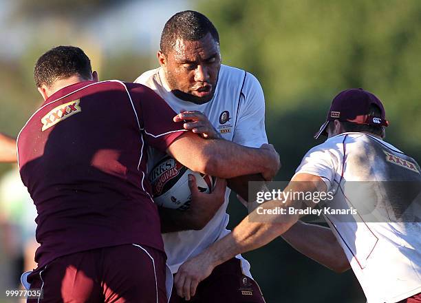 Petero Civoniceva takes tacklers at the Queensland Maroons State of Origin team fans day and training session held at Stockland Park on May 19, 2010...
