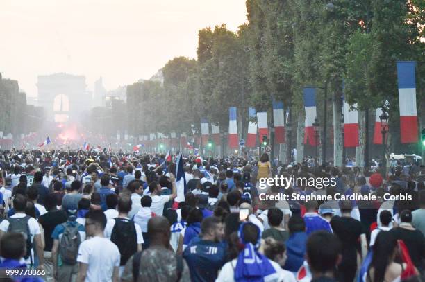 Fans celebrate the Victory of France in the World Cup 2018, on the Champs Elysees on July 15, 2018 in Paris, France.