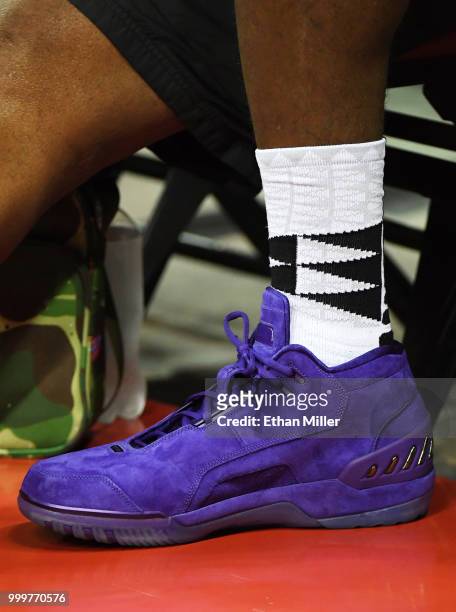 LeBron James of the Los Angeles Lakers wears purple suede Nike Air Zoom Generation sneakers as he attends a quarterfinal game of the 2018 NBA Summer...