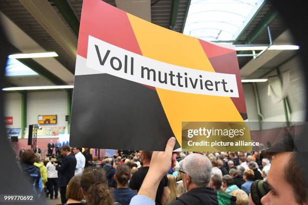 Supporters hold up a poster that reads "Fully mothervated" during a CDU election campaign event in Wolgast, Germany, 08 September 2017. Photo: Stefan...