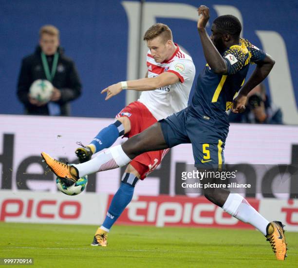 Hamburg's Andre Hahn and Leipzig's Dayot Upamecano vie for the ball during the Bundesliga soccer match between Hamburg SV and RB Leipzig in the...