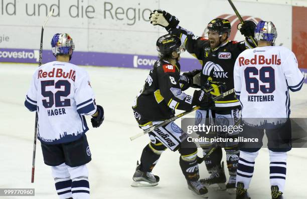 Krefeld's Martin Schymanski and Mathias Trettens celebrate a goal during the icehockey first league game between Krefeld Penguins and EHC Red Bull...