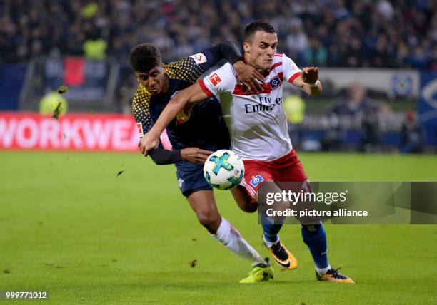 Hamburg's Filip Kostic and Leipzig's Bernardo vie for the ball during the Bundesliga soccer match between Hamburg SV and RB Leipzig in the...