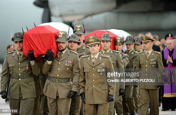 Italian Alpine troops carry the coffins of two comrades of the NATO-led International Security Assistance Force killed by an improvised explosive...