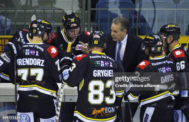 Krefeld's coach Marian Bazany instructs his team during the icehockey first league game between Krefeld Penguins and EHC Red Bull Munich in the...