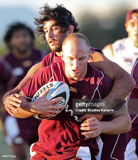 Darren Lockyer is tackled by team mate Johnathan Thurston during the Queensland Maroons State of Origin team fans day and training session held at...