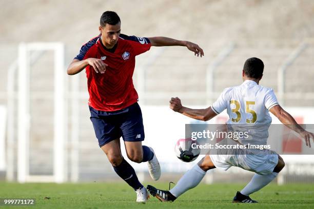 Anwar El Ghazi of Lille, Lorenzo Diaz of Reims during the Club Friendly match between Lille v Reims at the Stade Paul Debresie on July 14, 2018 in...