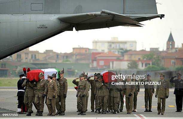 Italian Alpine troops carry the coffins of two comrades of the NATO-led International Security Assistance Force killed by an improvised explosive...