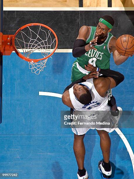 Rajon Rondo of the Boston Celtics takes the ball to the basket against Dwight Howard of the Orlando Magic in Game Two of the Eastern Conference...