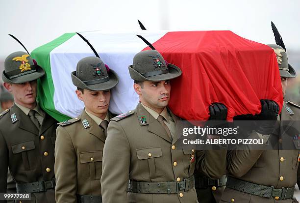 Italian Alpine troops carry the coffin of one of two comrades of the NATO-led International Security Assistance Force killed by an improvised...