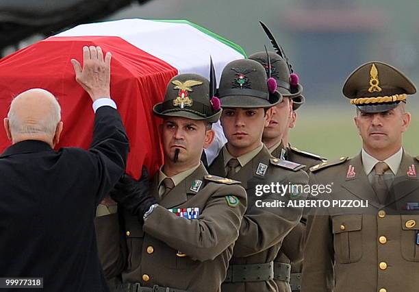 Italian President Giorgio Napolitano pays his respects at a coffin of one of the two Italian Alpine troops of the NATO-led International Security...