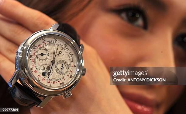 Model Rien holds a Patek Philippe Reference 5002P watch, otherwise known as the Sky Moon Tourbillon, during a Christie's viewing for their Spring...